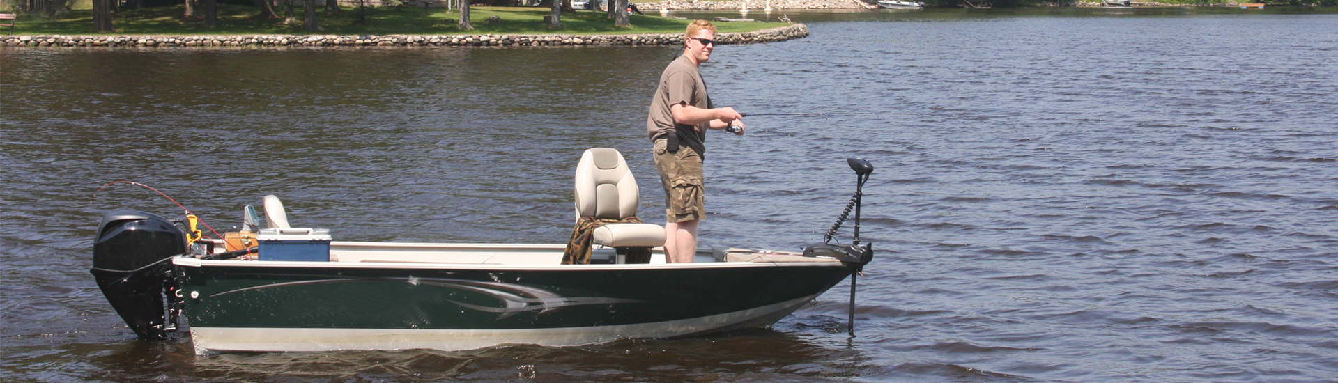 Young Man Fishing From the Skiff Boat